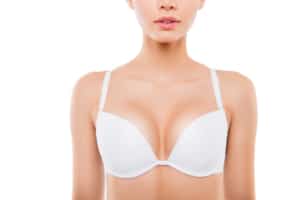 Close up of woman with perfect chest in white bra